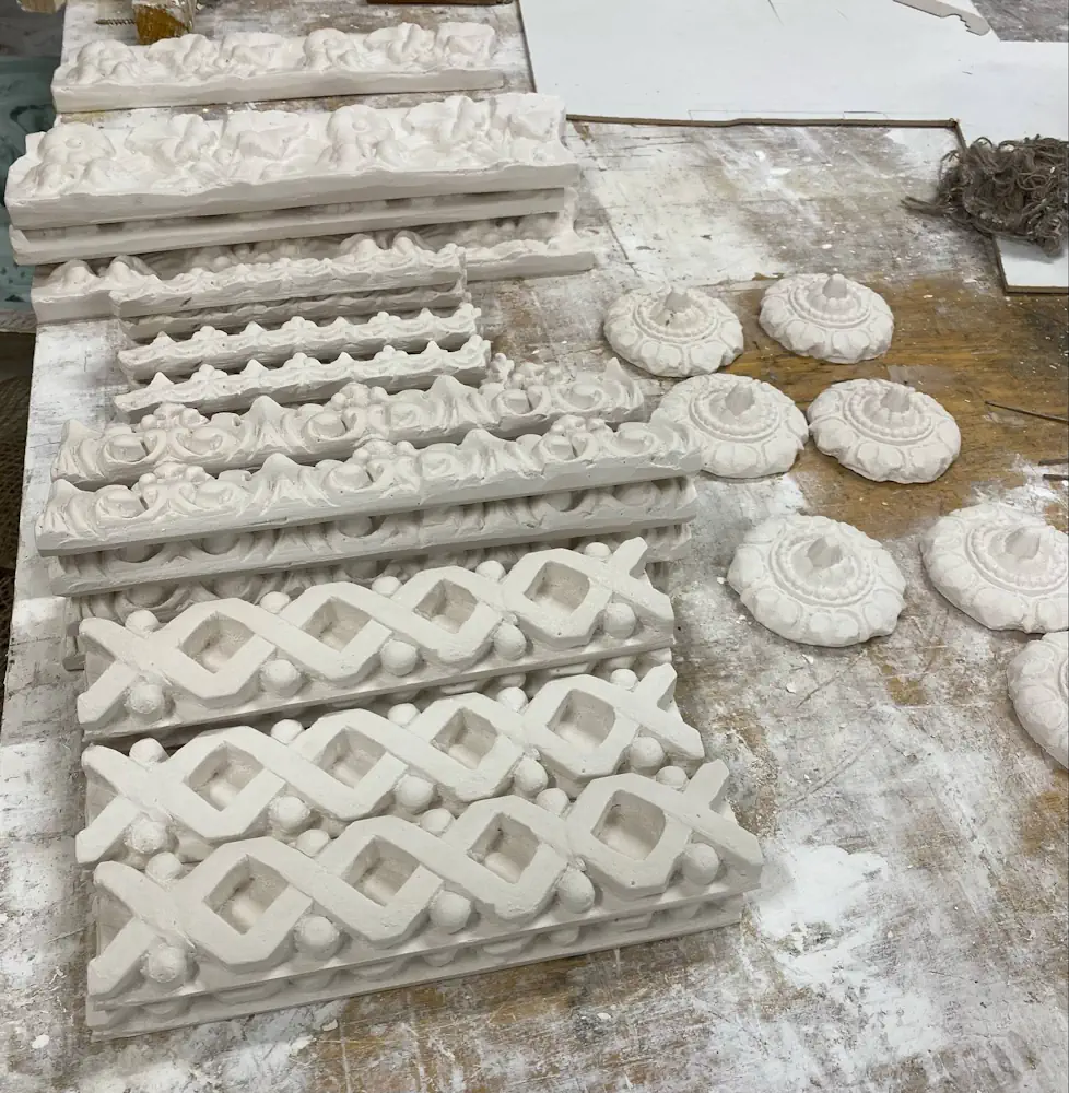 Ornamental plaster cornice sections and ceiling rose casts laid out for restoration work – Domestic Repairs – Glasgow